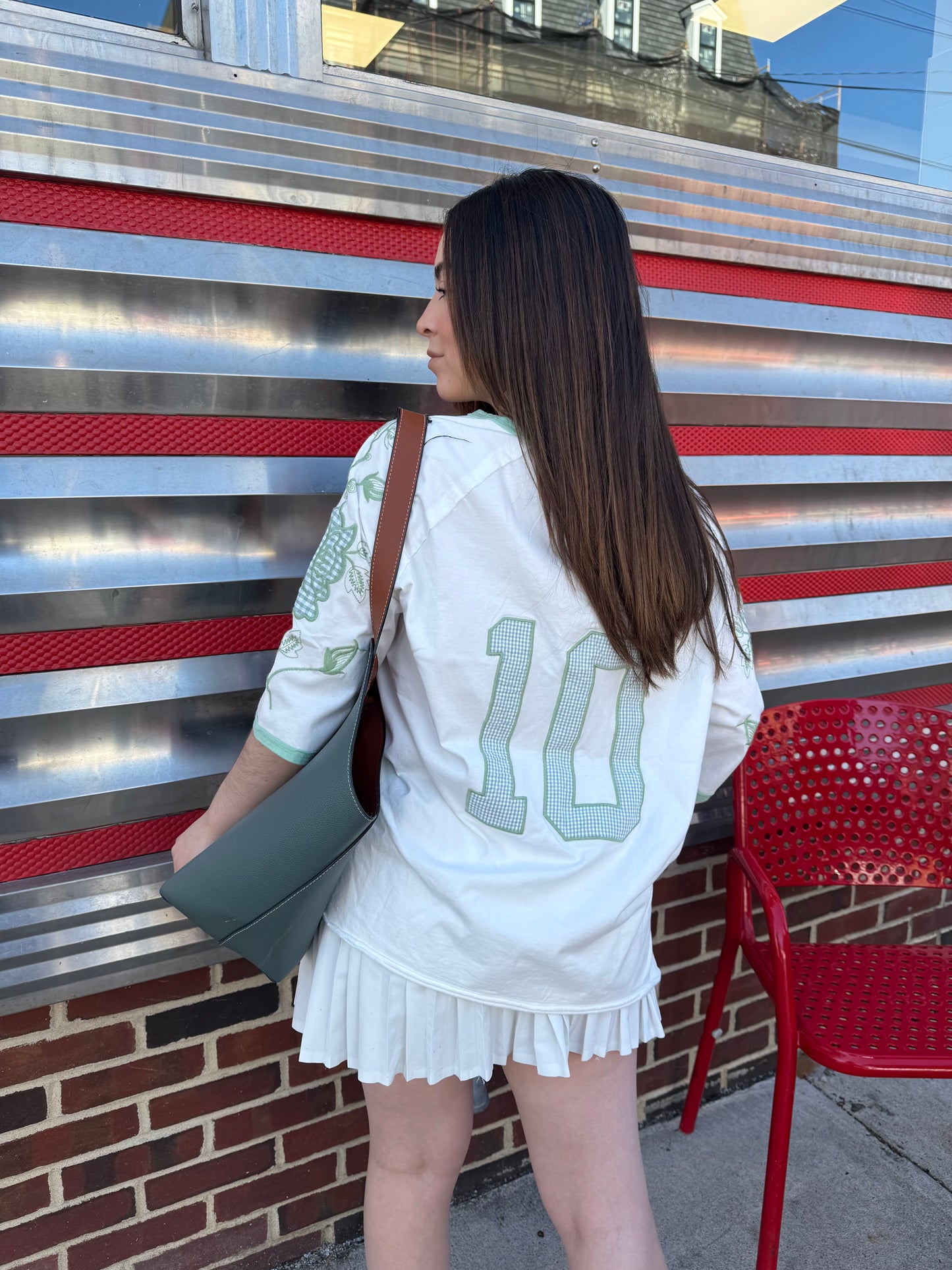  vintage '60's oversized t-shirt inspired with a cotton garment washed fabrication. Raglan sleeves for a cool relaxed fit. Count on a mixed media appliqué on sleeves and a gingham jersey numbered appliqué on back. 100% COTTON