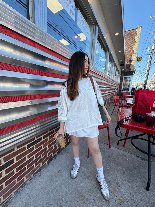  vintage '60's oversized t-shirt inspired with a cotton garment washed fabrication. Raglan sleeves for a cool relaxed fit. Count on a mixed media appliqué on sleeves and a gingham jersey numbered appliqué on back. 100% COTTON