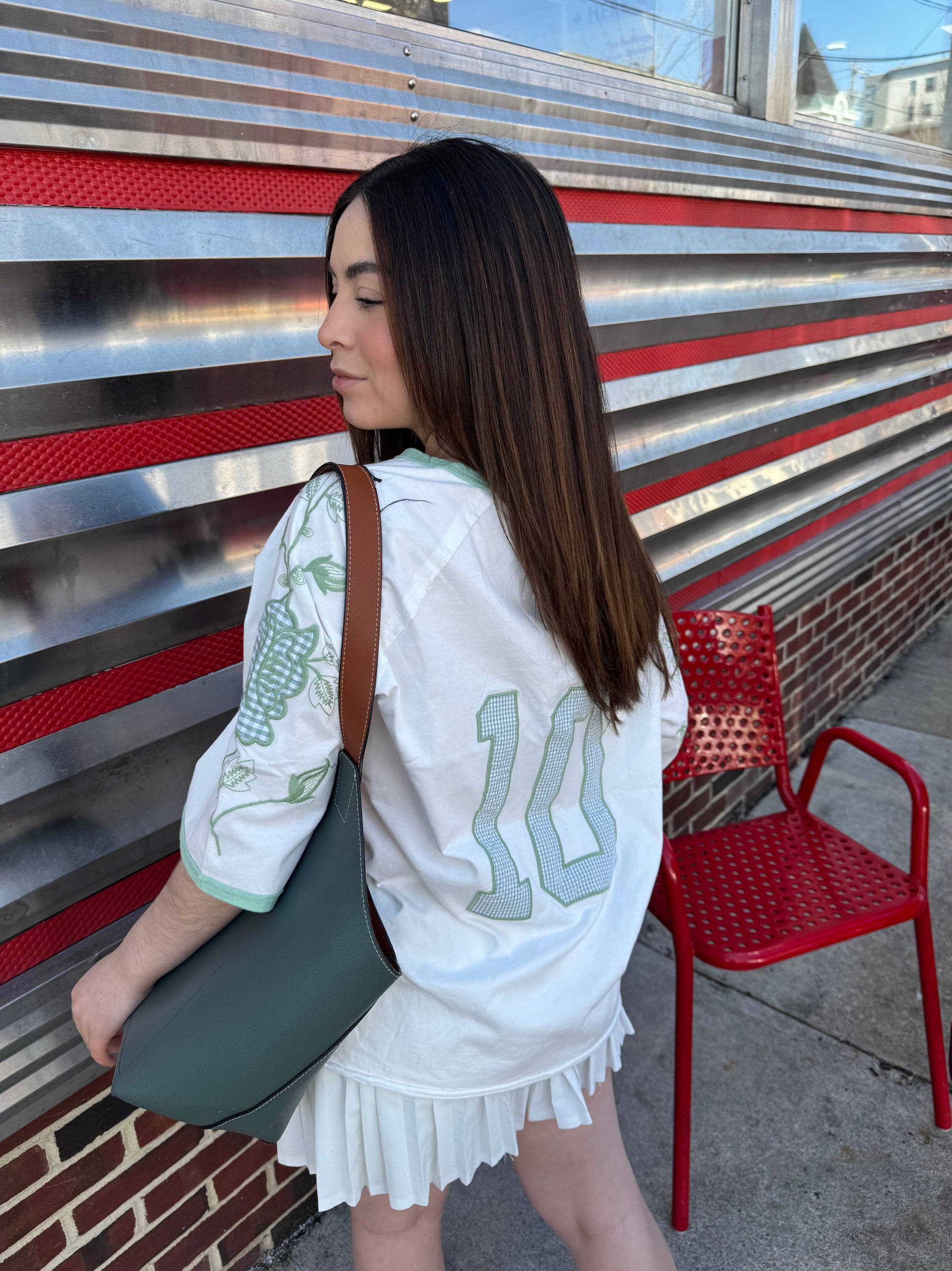  vintage '60's oversized t-shirt inspired with a cotton garment washed fabrication. Raglan sleeves for a cool relaxed fit. Count on a mixed media appliqué on sleeves and a gingham jersey numbered appliqué on back. 100% COTTON