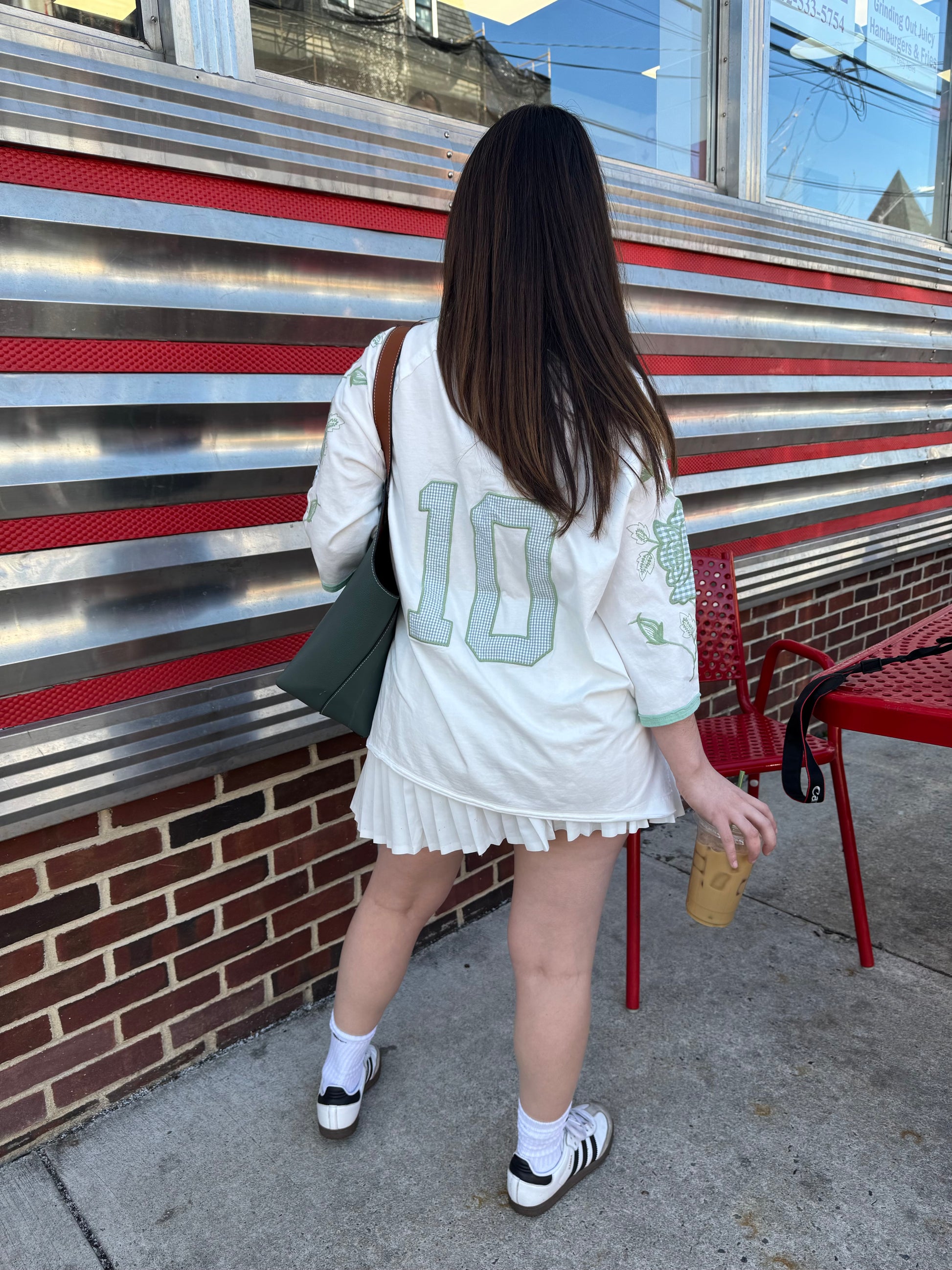  vintage '60's oversized t-shirt inspired with a cotton garment washed fabrication. Raglan sleeves for a cool relaxed fit. Count on a mixed media appliqué on sleeves and a gingham jersey numbered appliqué on back. 100% COTTON